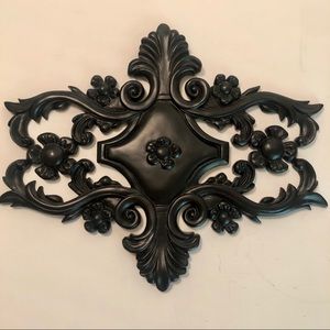 Scroll wall plaque in black.